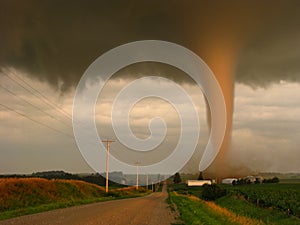 Actual photograph of a tornado at sunset narrowly missing a farm in rural Iowa.