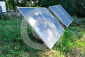 Actually used solar panels with traces of rust from the rain, close-up. Green energy in countryside. Concept of eco