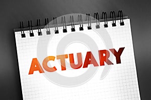 Actuary - business professional who deals with the measurement and management of risk and uncertainty, text concept on notepad