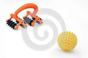 Acupressure body massager and massage ball on a white background.