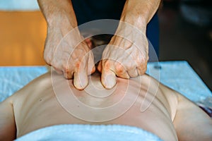 Acupressure massage in spa centre. Woman at acupressure back massage, masseur`s hands close up. Body therapy for healthy lifestyl