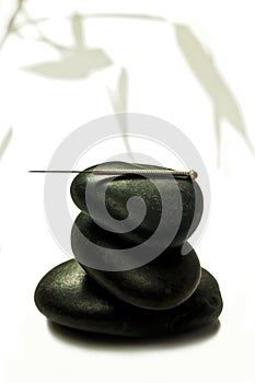 Acupuncture needle on stone