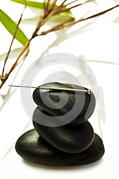 Acupuncture needle on stone