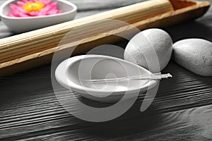 Acupuncture needles in bowl photo