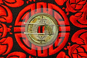 Acupuncture needles on coin and symbol for immortality