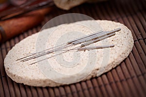 Acupuncture needles on the stone mat