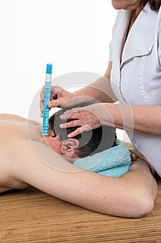 Acupuncture therapist using moxibustion on the back of patient