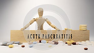 Acute pancreatitis leukaemia written on wooden surface. Wooden man and medicine concept