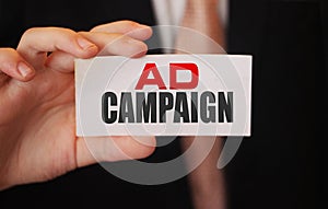 Ad Campaign on a card businessman shows. Advertising and marketing business concept