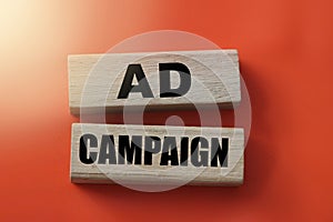 Ad Campaign on Wood Blocks on red background. Marketing Business Concept