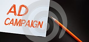 Ad campaign words and orange pencil. Advertising marketing business concept.