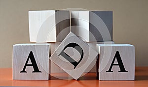 ADA - acronym on large wooden cubes on light brown background