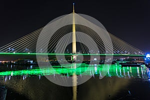 Ada bridge (Most na Adi) and green glow over Sava river and small marina in Belgrade, Serbia