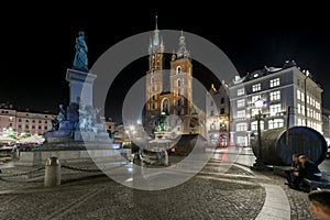 Adam Mickiewicz monument and St. Mary's Church in Krakow photo