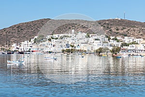 Adamas village with boats and mountain reflecting in Milos bay