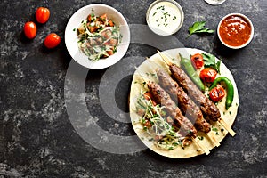 Adana Kebab with fresh vegetables on flatbread
