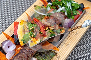 Adana-kebab with vegetables and pita bread - traditional Turkish dish