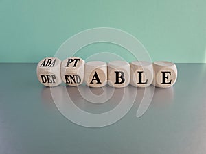 Adaptable or dependable symbol. Turned wooden cubes and changes the word dependable to adaptable