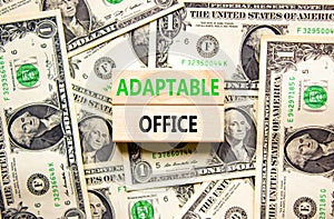 Adaptable office symbol. Concept words Adaptable office on beautiful wooden block. Beautiful dollar bills background. Dollar bills
