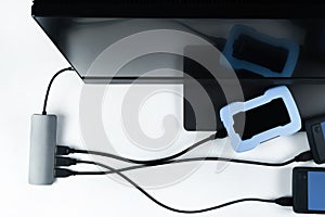 Adapter with connection of external hard drives connected to a monoblock on a white background.Computer with a hard disk