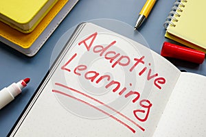 Adaptive learning handwritten sign and yellow books.