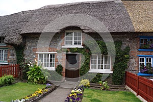 Adare, County Limerick, Ireland: traditional thatched cottage with front garden