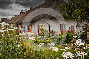 Adare, Ireland. Thatched cottage in the picturesque Village of Adare, Co. Limerick full of flowers in front garden 2019 Ireland,