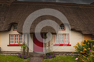 Adare, Ireland. Thatched cottage in the picturesque Village of Adare, Co. Limerick full of flowers in front garden 2019 Ireland,