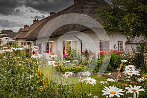 Adare, Ireland. Thatched cottage in the picturesque Village of Adare, Co. Limerick full of flowers in front garden 2019 Ireland, photo