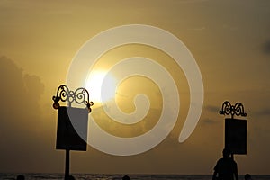 Adboards in the beach with a sun setting in background