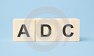 ADC word written on wooden cubes with copy space
