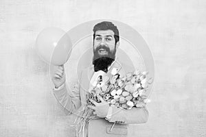 Add holiday cheer with this festive bouquet. Bearded man hold tulips and balloon. Holiday celebration. Happy valentines