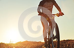 Add a little adventure to your day. an unidentifiable mountain biker out on a trail on a sunny day.