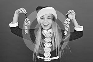 Add more decorations. Christmas decorating ideas. Child Santa Claus costume hold christmas candy cane. Create unique