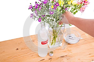 Add vodka and sugar into vase to keep flowers fresher