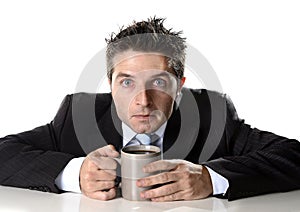 Addict businessman holding cup of coffee anxious and crazy in caffeine addiction