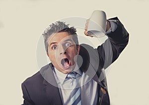 Addict businessman holding empty cup of coffee in caffeine addiction concept