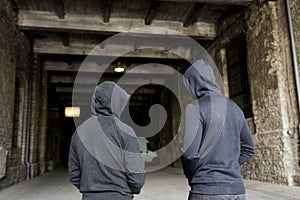 Addict men or criminals in hoodies on street