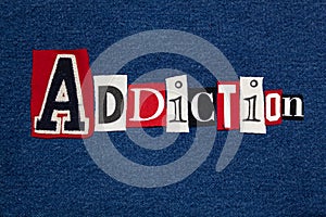 ADDICTION text word collage, colorful fabric on blue denim, health and addiction concept