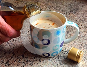 Adding brandy alcohol to coffee.