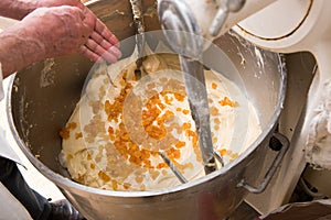 Adding candied fruit to raw dough in a blender