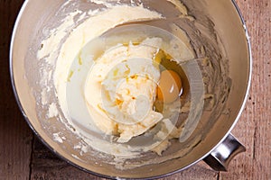 Adding egg to mixed butter with sugar