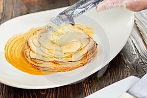 Adding ice cream ball to an apple tart.