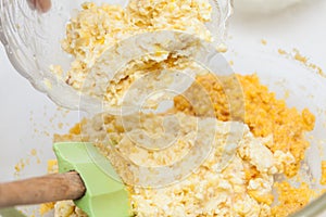 Adding shredded corn kernels to prepare sweet corn bread