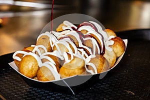 Adding a topping to donuts