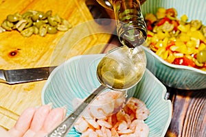 Adding white wine in shrimps for cooking