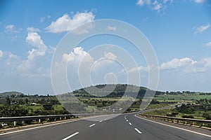 Addis Ababa Highway surrounded by green trees and mountains - Ethiopia