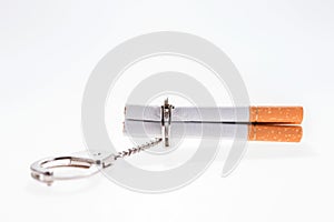 Addition concept with cigarettes and handcuffs on white