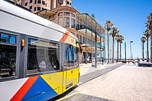 Adelaide tram at the terminus at Moseley square in Glenelg and view of the beach and jetty in the distance in Glenelg SA Australia