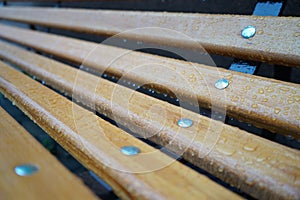 Adetail of wooden bench in the rain